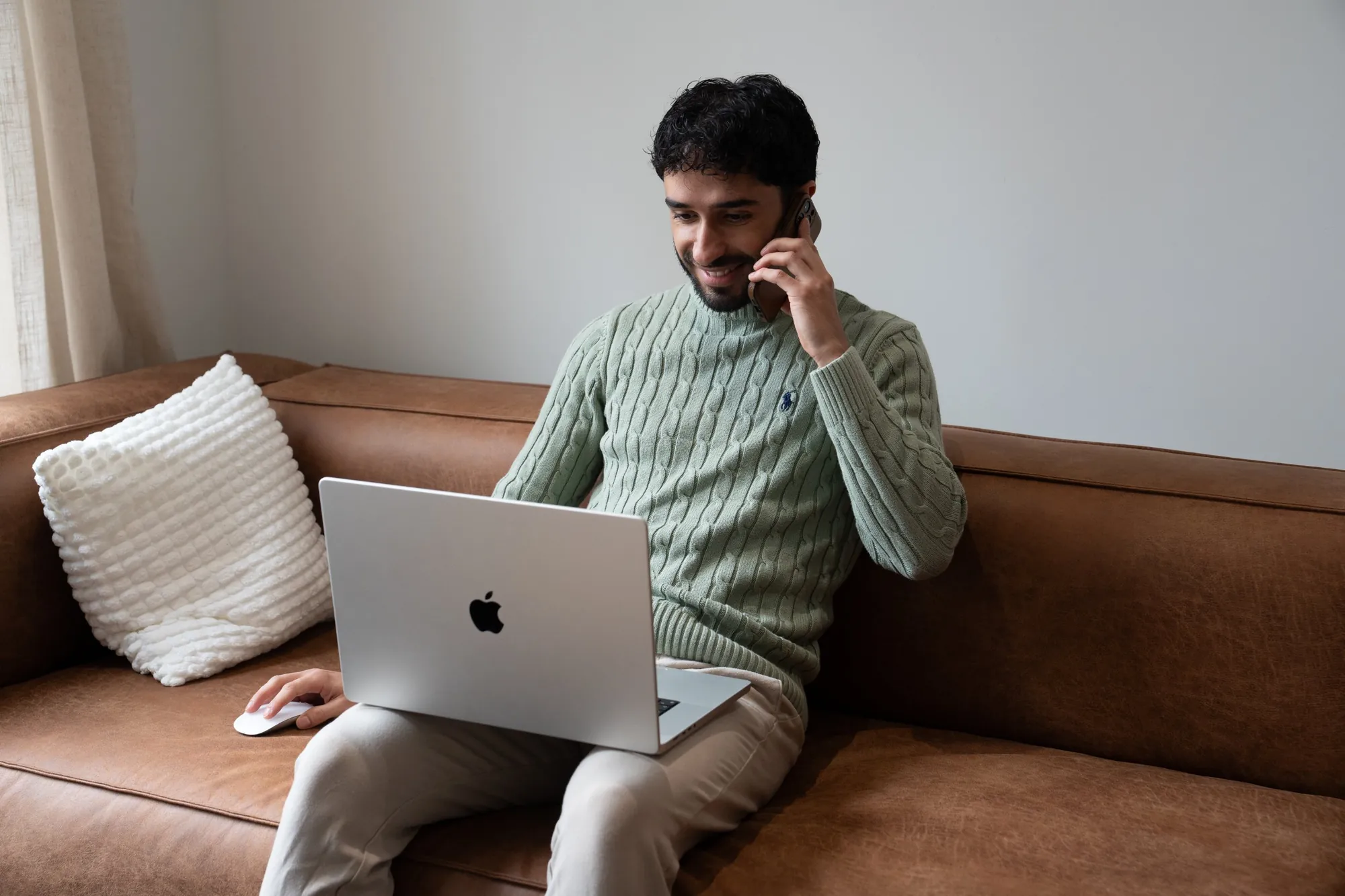 MrRecruit.Me team member working on a laptop on the office sofa